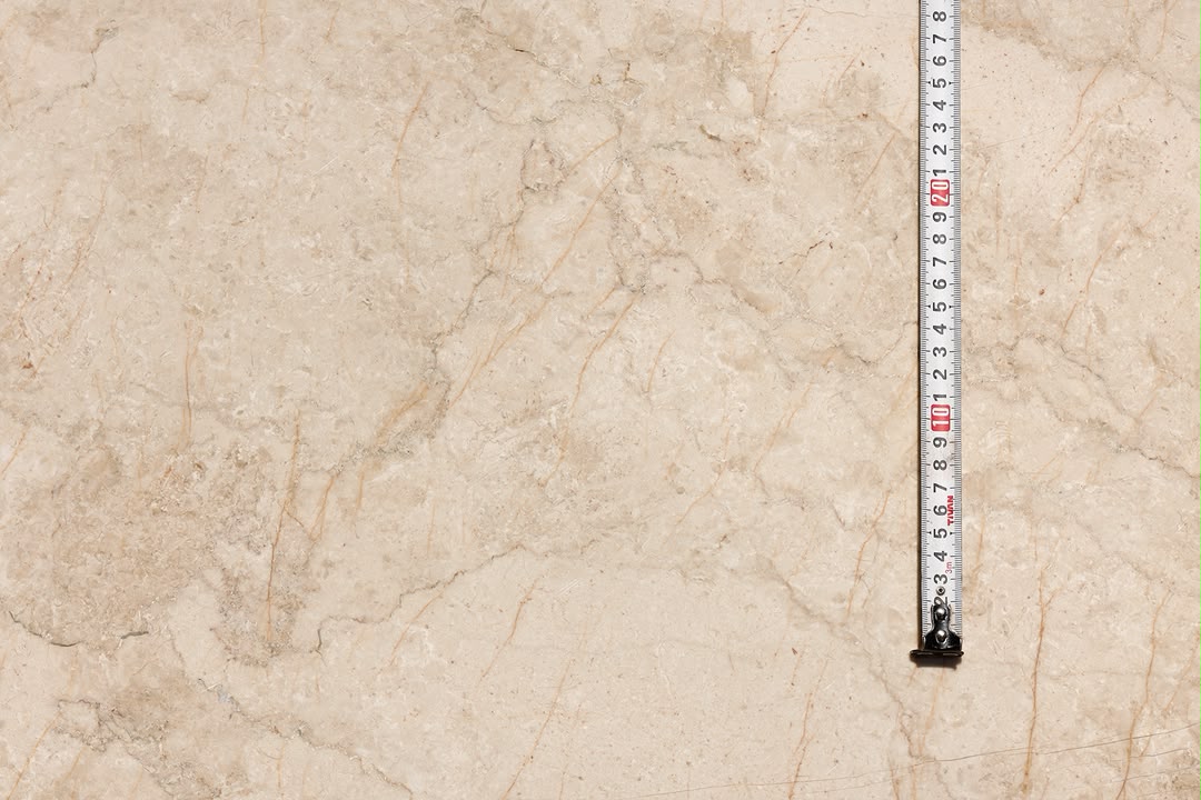 Close-up of our beige stone photographed with a measuring tape